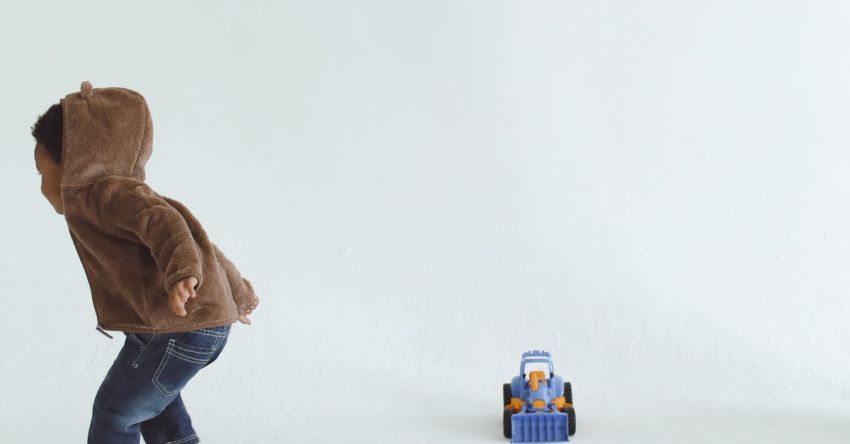 Activities - A Child Playing with a Mat of Colors