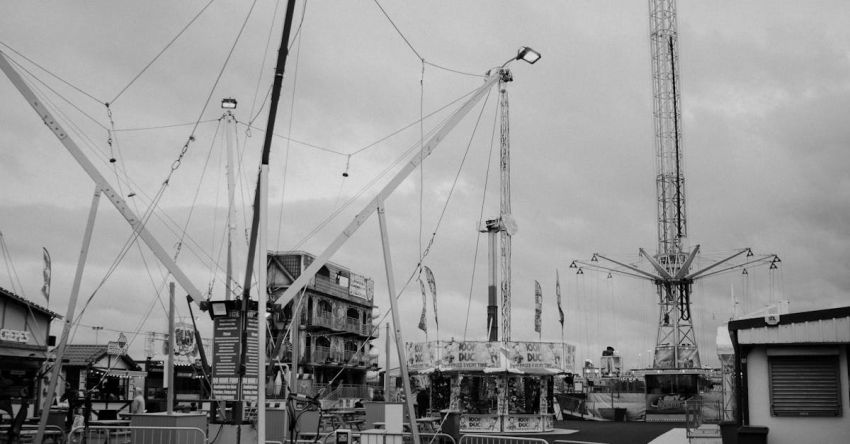 Attractions - Black and white photo of carnival rides at the fair