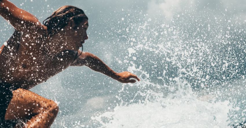 Activities - Man Riding White Surfboard